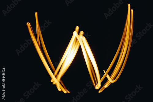 Created by light letter W over black background