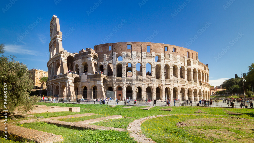 Crowd of tourists visiting the iconic monument Colosseum in Rome, Italy