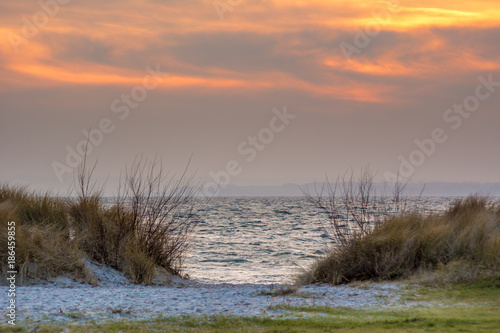 Baltic Sea and sand dunes at sunset time. Poland.