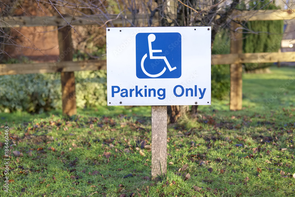 Disabled parking only sign post in rural countryside car park Disabled parking only sign post in rural countryside car park