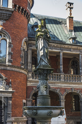 Figure of the Virgin Mary and Jeus on the column in the palace and park complex in Plawniowice