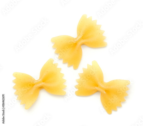 Three raw farfalle pasta isolated on white background top view.
