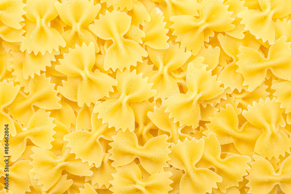 Raw farfalle top view background a lot of dry pasta pieces. Raw farfalle top view background a lot of dry pasta pieces.