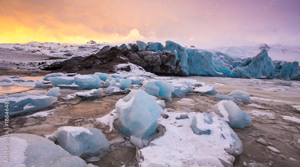 Famous Fjallsarlon glacier and lagoon with icebergs swimming on frozen water. Famous Fjallsarlon glacier and lagoon with icebergs swimming on frozen water.