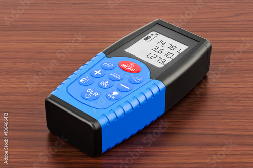 фотографія Laser rangefinder on the wooden table. 3D rendering