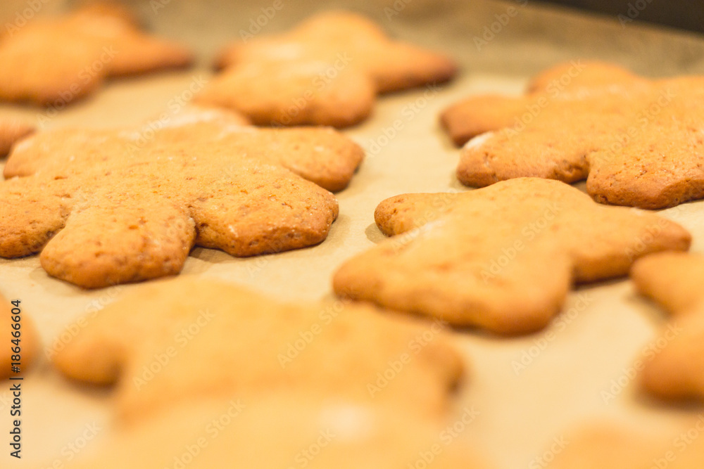 Ginger biscuits lie on a baking sheet. Cookies on baking paper. Selective focus. Ginger biscuits lie on a baking sheet. Cookies on baking paper. Selective focus.
