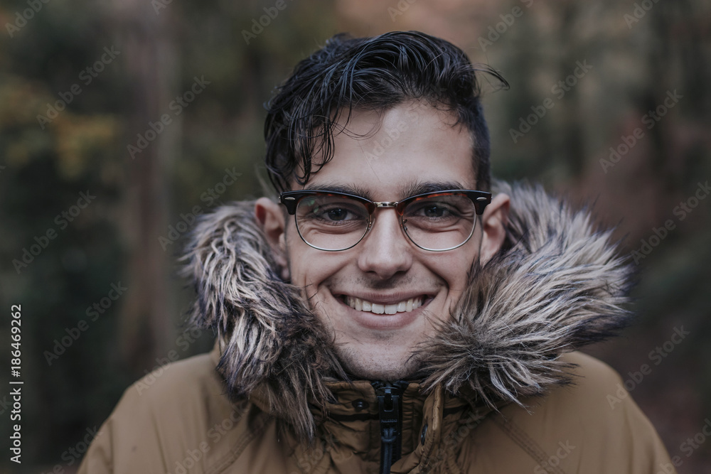portrait of young man in the forest in autumn or winter portrait of young man in the forest in autumn or winter