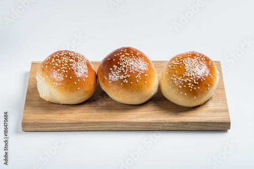 Burger bread bun isolated on white background. Top flat view, from above.