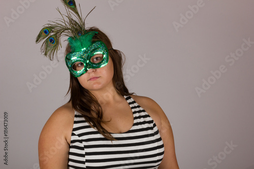 Beautiful Curvy Teenage Girl in Black and White Dress with Green Masquerade Mask