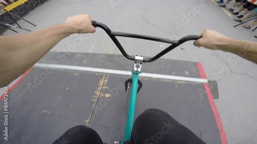 bmx pov double tailwhip over big jump slow motion photo