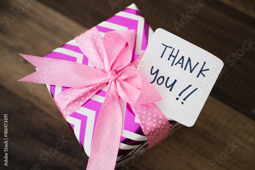 present / gift with a thank you note. handwritten thank you note on a gift / present. thank you card with copy space.