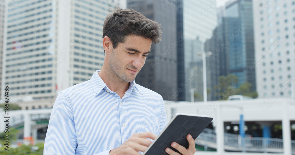 Businessman hold with tablet computer in city Businessman hold with tablet computer in city