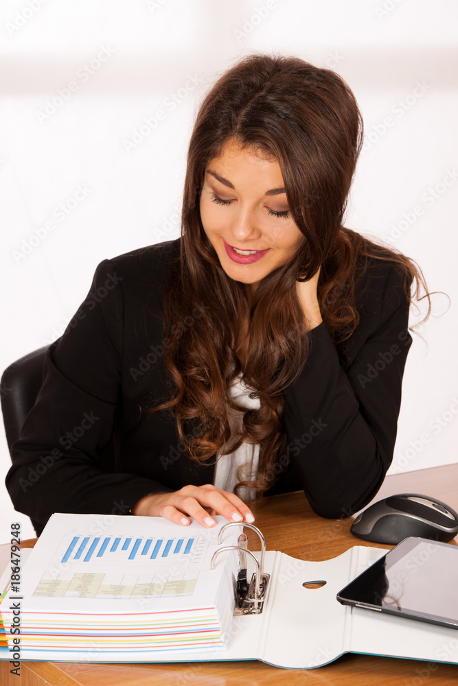 Beautiful young brunette business woman work in her office Beautiful young brunette business woman work in her office