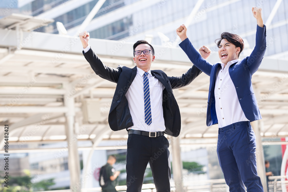 Asian two businessmen happy are working in city Asian two businessmen happy are working in city