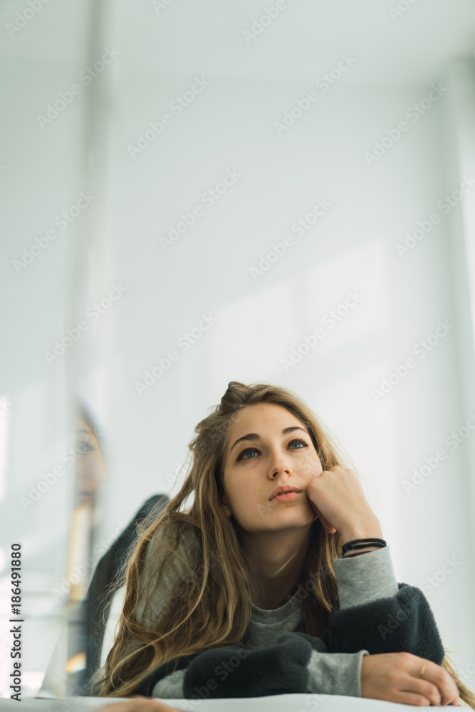 Beautiful woman in sweater cuddling in bed Beautiful woman in sweater cuddling in bed