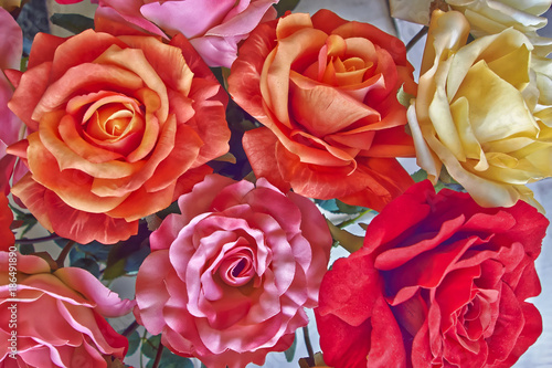 variety of colorful  fake roses  floral background