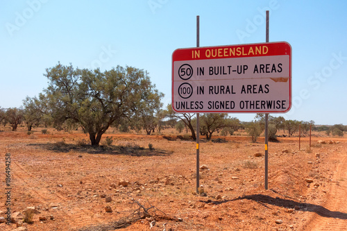 Sign showing speed restrictions on the Northern Territory and Queensland state boundary