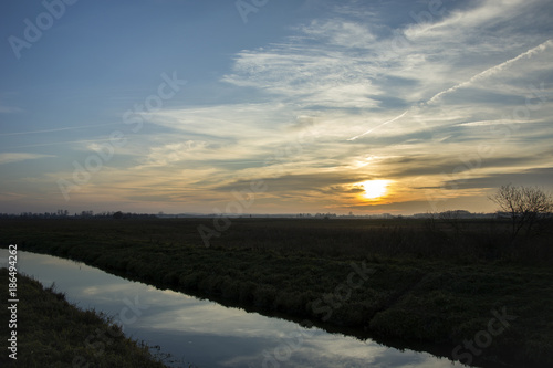 Sunset over the meadows and the river