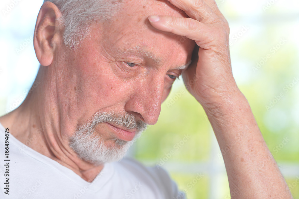 Obraz premium Sad senior man at home