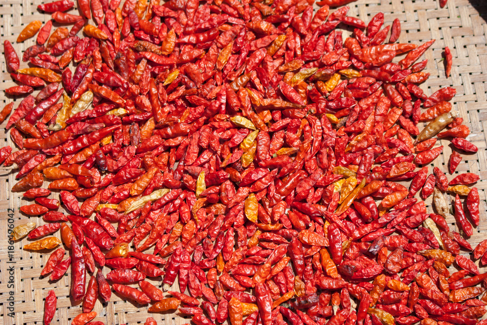Fototapeta premium red chills in basket on the ground