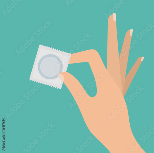 Woman's hand holding packed condom