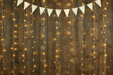 dark wood background with lights and flags, abstract holiday backdrop, copy space for text