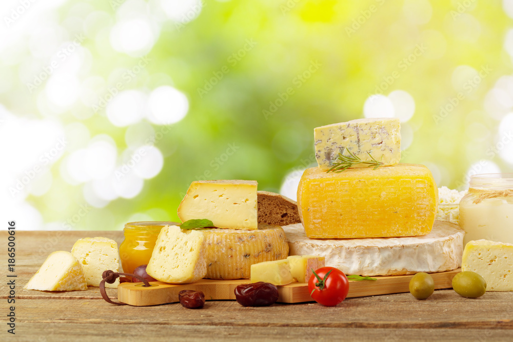 Tasty beautiful cheese composition on wooden board