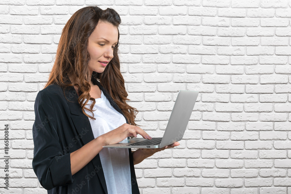 Portrait of young beautiful brunnete woman holding laptop Portrait of young beautiful brunnete woman holding laptop