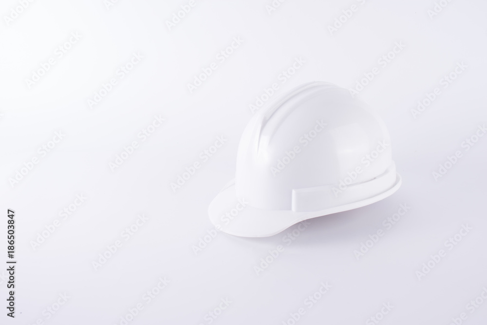 White safety helmet on white background. Hard hat and thick gloves on white isolated background. Safety equipment concept. Worker and Industrial theme. White safety helmet on white background. Hard hat and thick gloves on white isolated background. Safety equipment concept. Worker and Industrial theme.