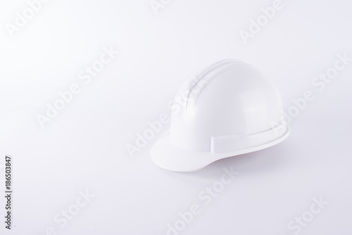 White safety helmet on white background. Hard hat and thick gloves on white isolated background. Safety equipment concept. Worker and Industrial theme.