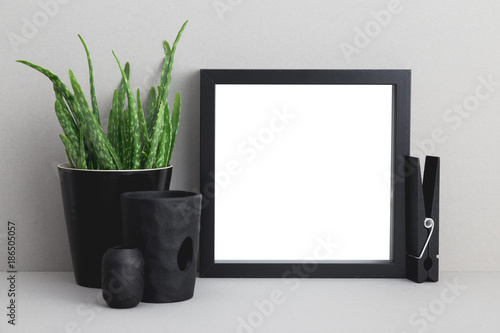 Photo frame and a flower on a shelf mock up. photo