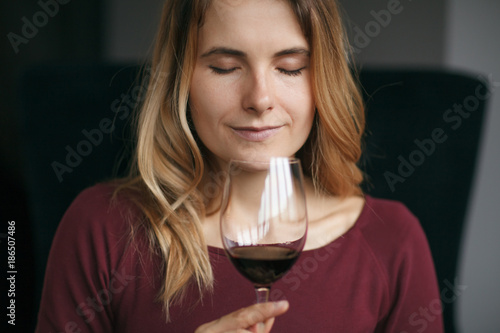 Attractive woman drink red wine in the restaurant