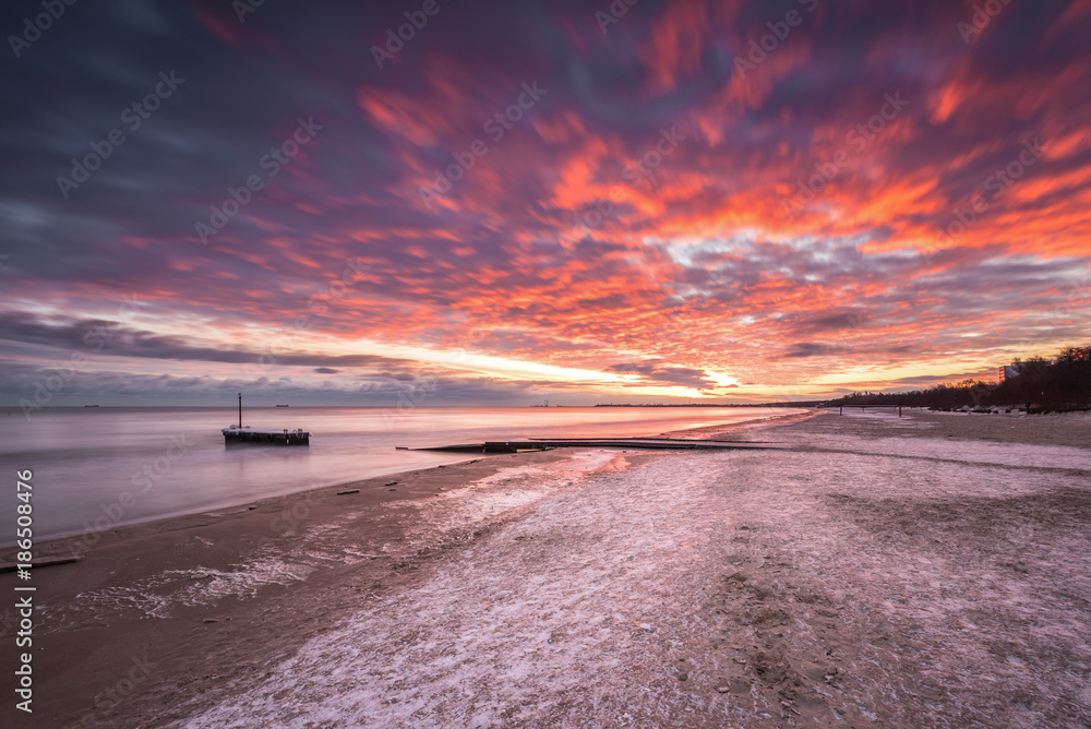 Winter landscape with colorful sunrise at the beach in Gdansk in Poland. Baltic Sea. Winter landscape with colorful sunrise at the beach in Gdansk in Poland. Baltic Sea.