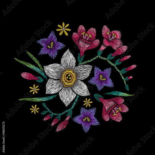 Fototapeta Naklejka Na Ścianę i Meble -  Embroidery circle floral pattern with narcissus, freesia and bellflower on black background