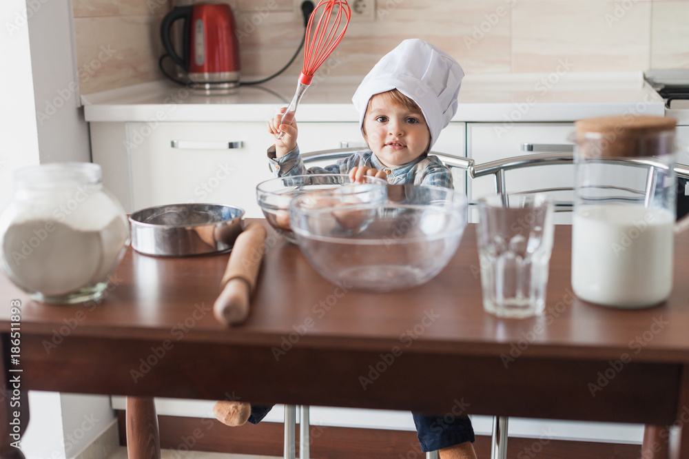 little kid in chef hat holding whisk in hand ready to cook little kid in chef hat holding whisk in hand ready to cook