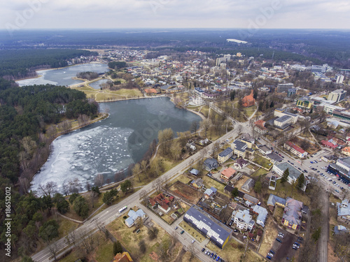 Aerial view over frozen lake Druskonis in Druskininkai, Lithuania. During cloudy winter day. photo