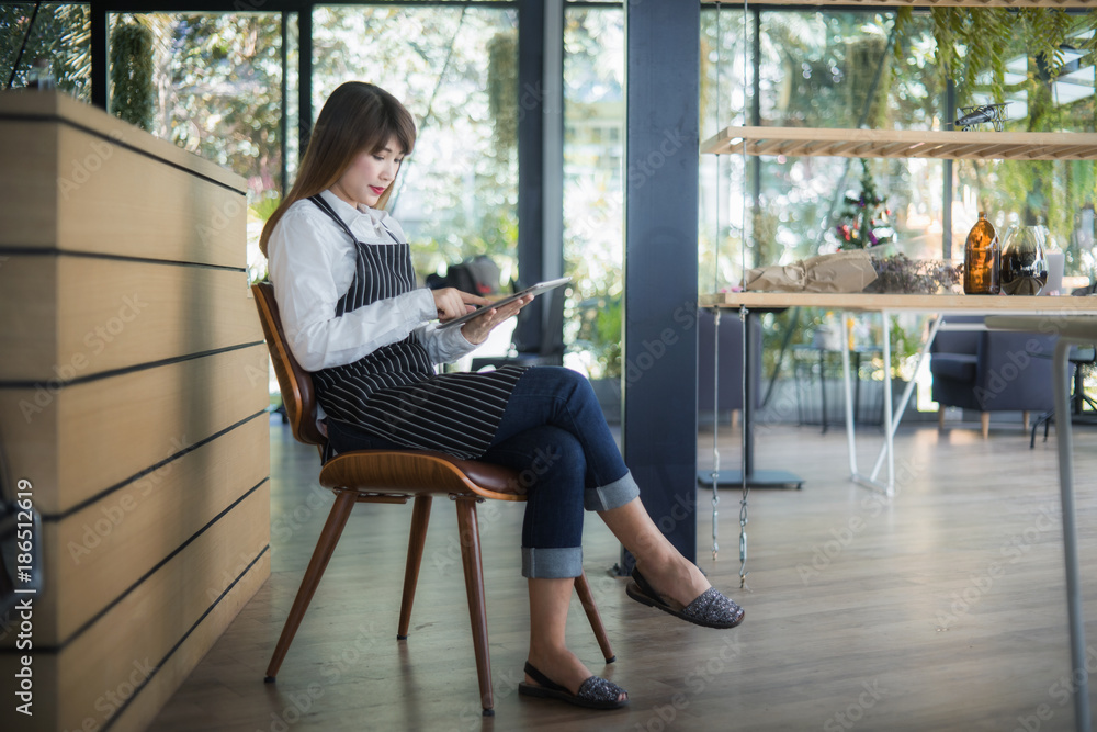Portrait of a smiling Asian entrepreneur using a digital tablet. Portrait of a smiling Asian entrepreneur using a digital tablet.