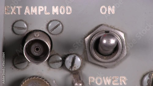 Close-up macro of old fashioned output toggle switch being turned on then off on radio transceiver vintage electronic hardware engineering equipment
