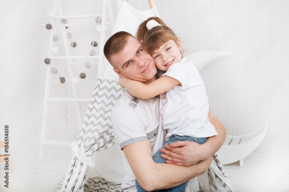 Obraz premium happy daughter hugging father in the kid bedroom. Happy family spending time at home.