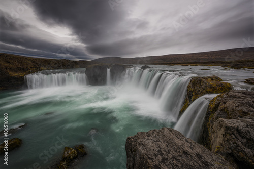 Dark clouds linger above Godafoss in Iceland 