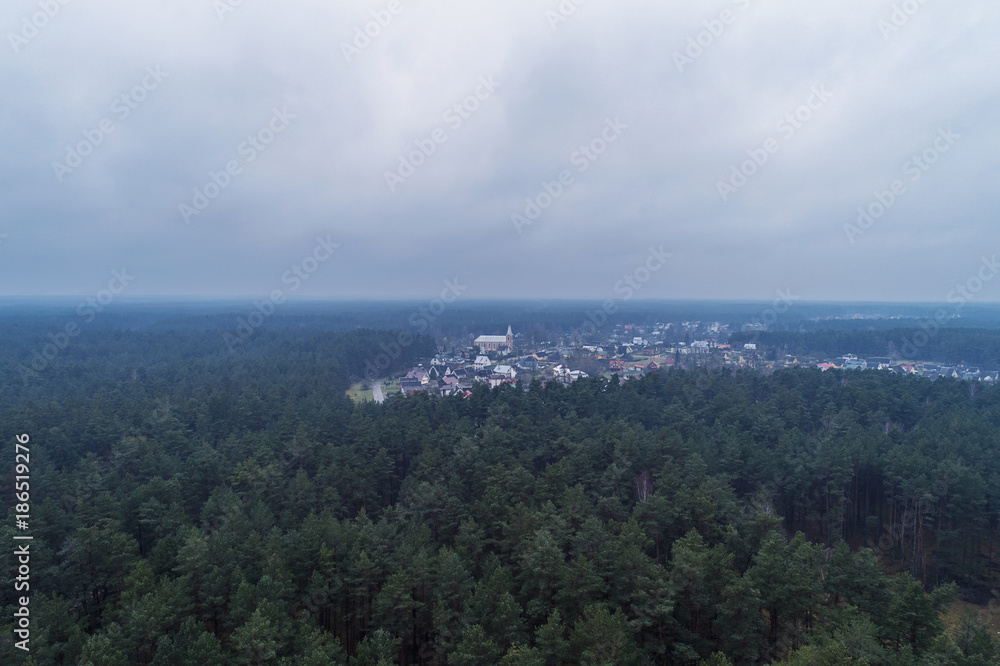 Aerial view over small village Ratnycia, near resort town Druskininkai, Lithuania. During cloudy autumn day.