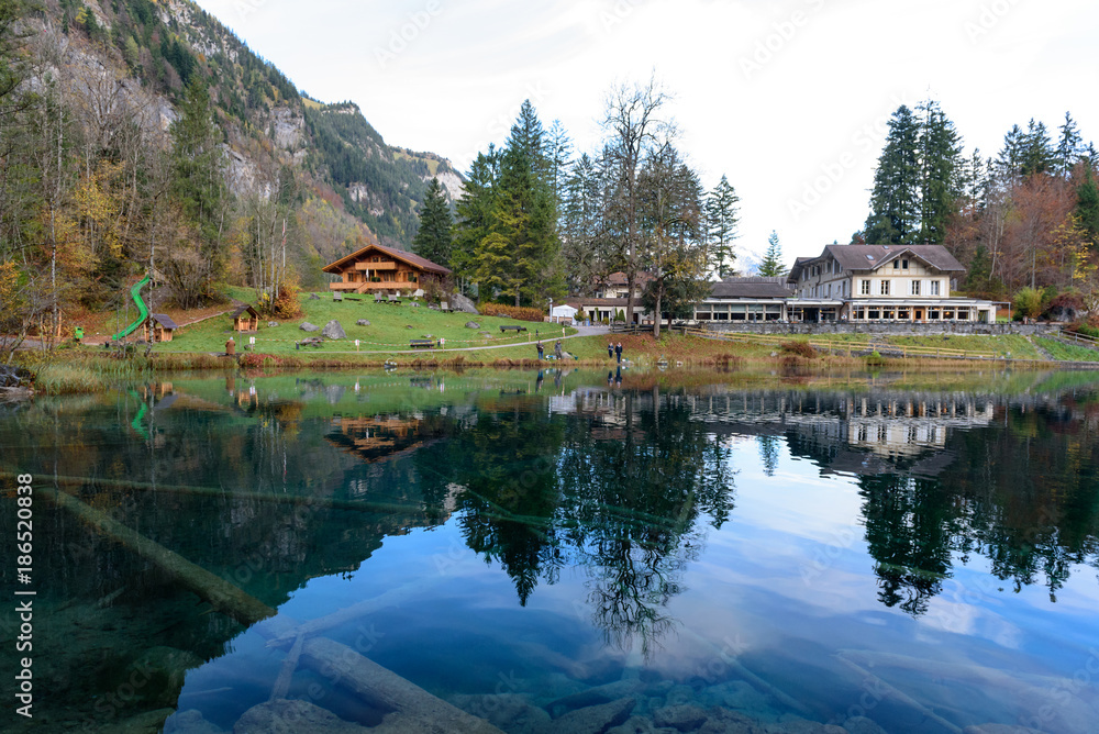 Fototapeta premium Beautiful crystal clear water at best-know Blausee lake in Kandersteg, Switzerland during autumn season