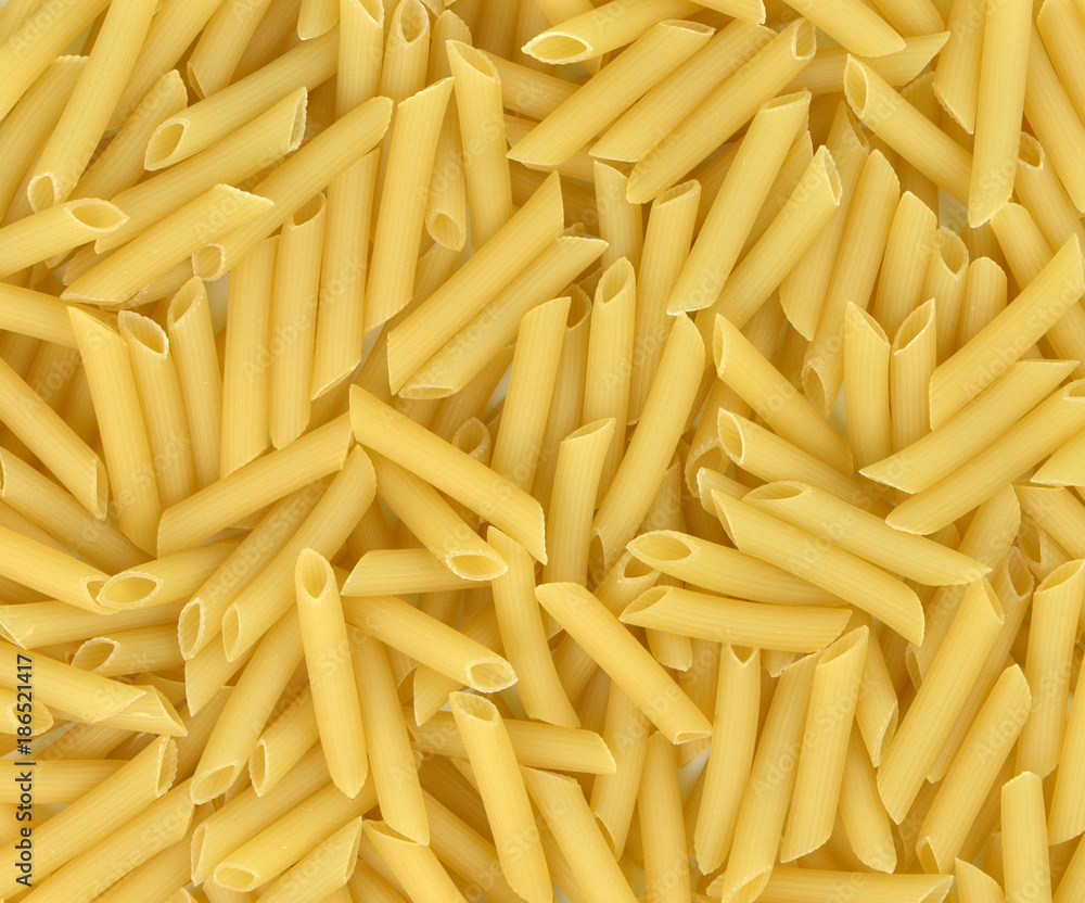 Background of pasta texture close-up.Full background of dry uncooked macaroni.Top view. Background of pasta texture close-up.Full background of dry uncooked macaroni.Top view.