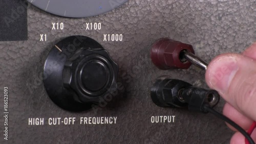 Connecting output cables and making high frequency cut-off scale adjustments to variable band-pass filter vintage electronic hardware engineering military equipment photo