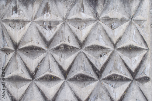 Background texture of gray concrete fence with triangular pattern