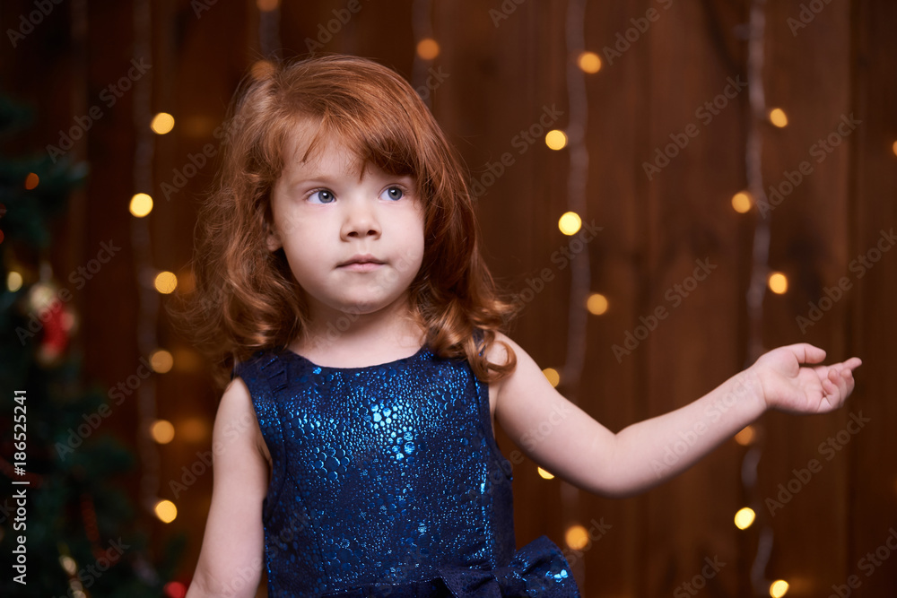 Christmas interior. Beautiful little girl. Blue dress Christmas interior. Beautiful little girl. Blue dress