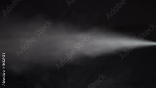 Stream of white smoke on an isolated black studio background