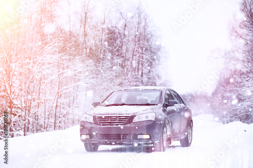 The car stands on a snow-covered road © alexkich
