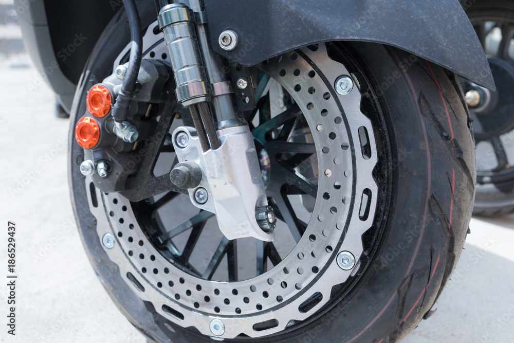 External brake disc of special design on motobike in sunny day External brake disc of special design on motobike in sunny day