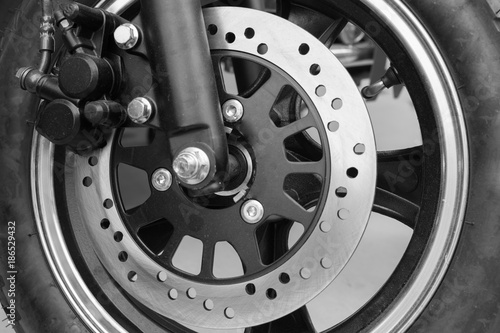 New brake disc on the front wheel of motobike - black and white